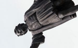 A statue of Christopher Columbus turned sideways.