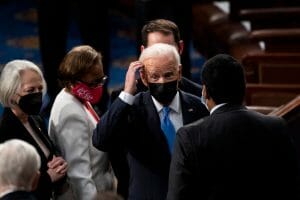 President Biden stands among several members of Congress.