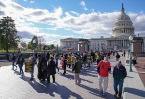 WASHINGTON, DC - NOVEMBER 15: Stewart Acuff of the West Virginia Poor Peoples Campaign and the Reverend William Barber walk ahead of activists and demonstrators during a march and demonstration at the US Capitol during the MoveOn and Poor People's Build Back Better Action on November 15, 2021 in Washington, DC. (Photo by Jemal Countess/Getty Images for MoveOn)