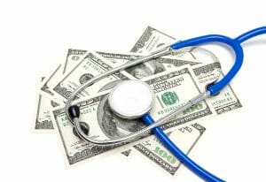 Stethoscope on US dollars isolated on white background