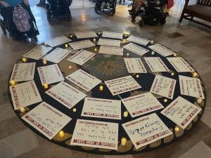 Caring Majority places "Because of home care" signs in the War Room.