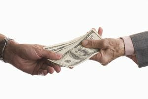 Detail of two people exchanging money