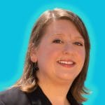 Woman looking at the camera in front of blue background