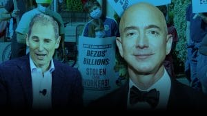 A person holds a sign saying Bezos Billions stolen from workers.